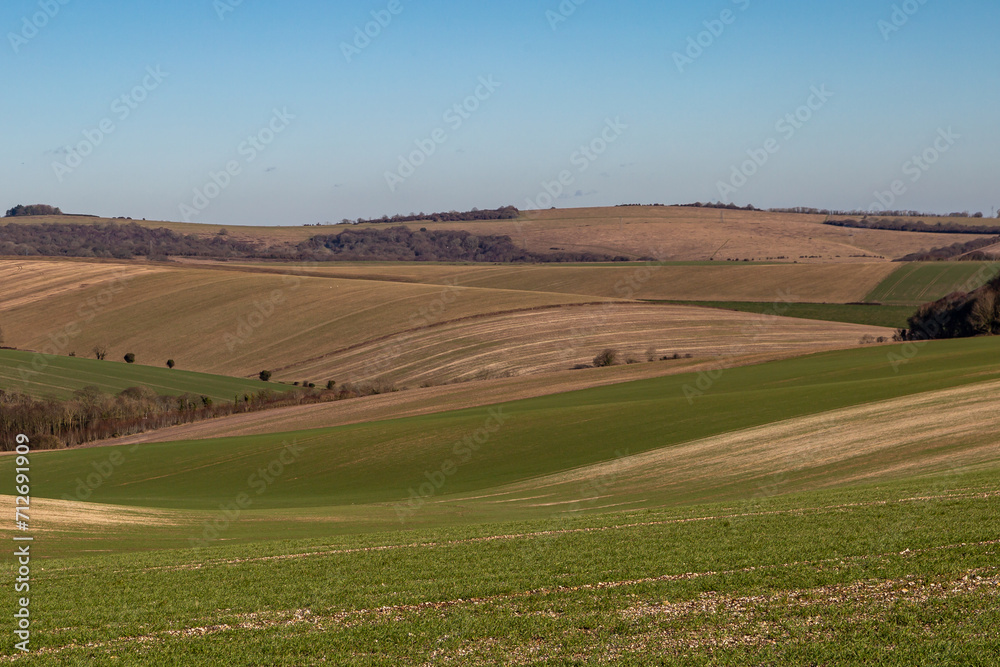 A rural Sussex landscape with a blue sky overhead