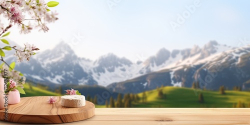 Wooden table stand with blurry spring mountain backdrop for food product display with nature theme.