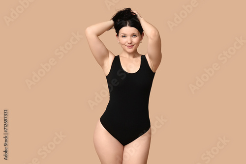 Body positive woman on beige background