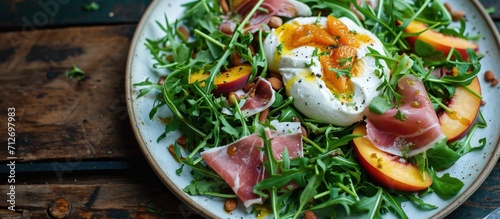 Nourishing summer salad with peach, burrata, arugula, and jamon. Healthy cuisine.