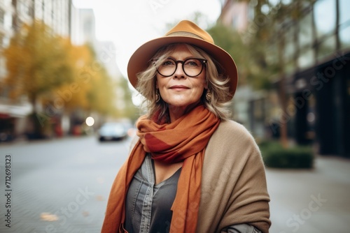 Portrait of a senior woman wearing hat and scarf in the city.