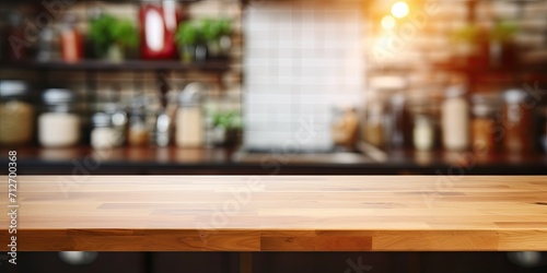 Blurred kitchen interior with empty wood table top  suitable for ads or presentations.