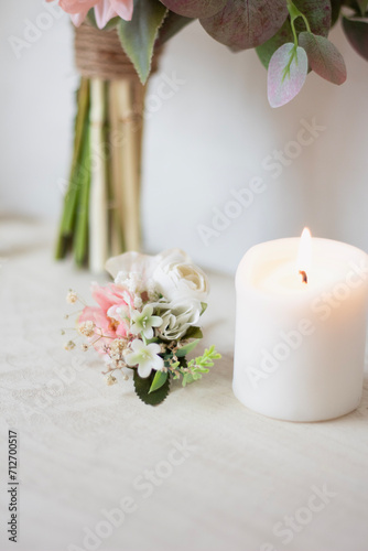 white groom boutonniere , ribbon and candle in one. wedding theme