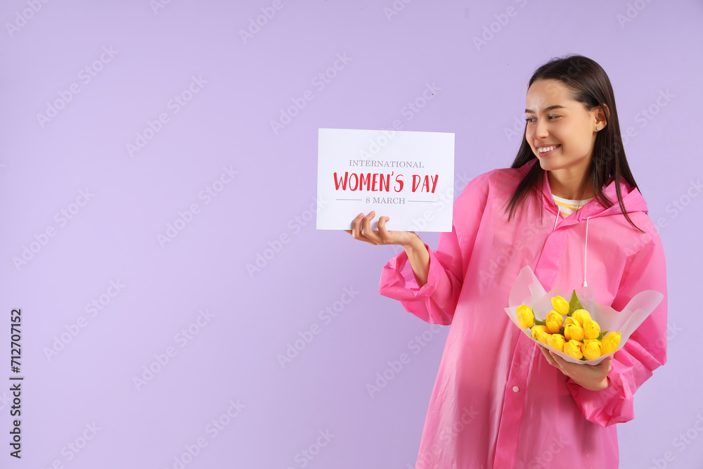 Young woman in raincoat with bouquet of tulips and card on lilac background. International Women's Day