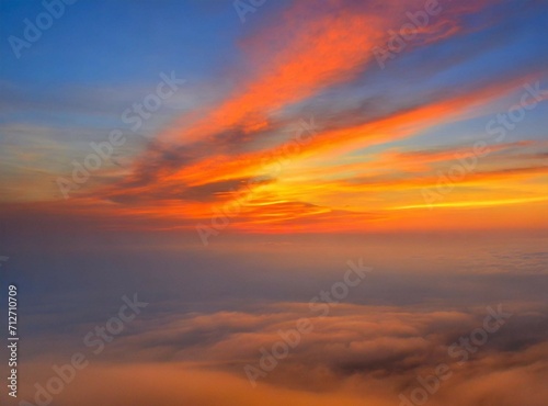 Sunrise on the sky, view from an airplane. Travel background/wallpaper with orange clouds and copy space.