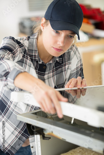 female carpenter installing table top