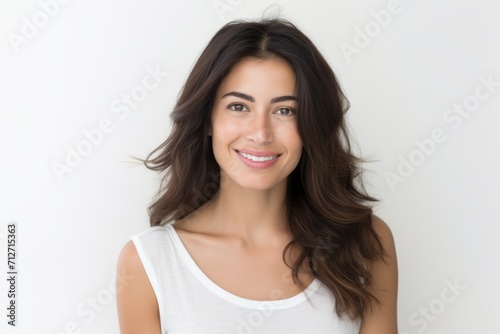 Portrait of a beautiful young woman smiling at the camera over white background