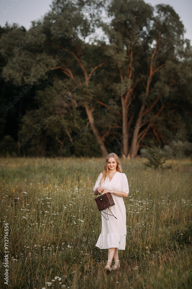A person standing in a field, wearing a wedding dress. 5651