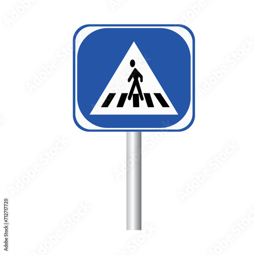 Blue and white pedestrian crossing sign on the sky background