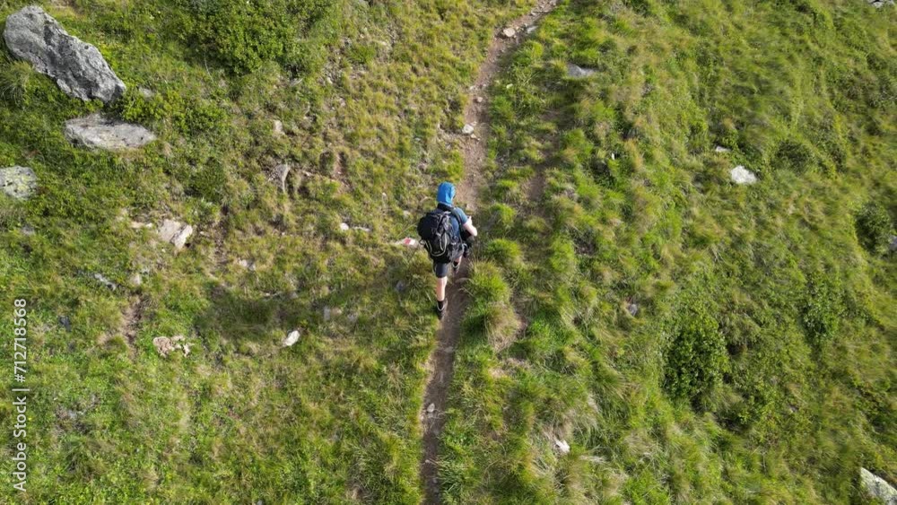 Top down view of male hiker (man) with trekking backpack hiking on path in Texel group mountains, South Tyrol, Italy Top down view of male hiker (man) with trekking backpack hiking on path in Texel group mountains, South Tyrol, Italy