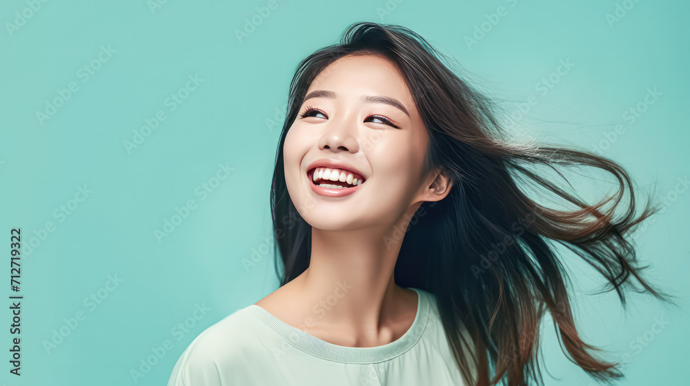 a girl of Asian appearance brightens a green background. a girl of Asian appearance brightens a green background.