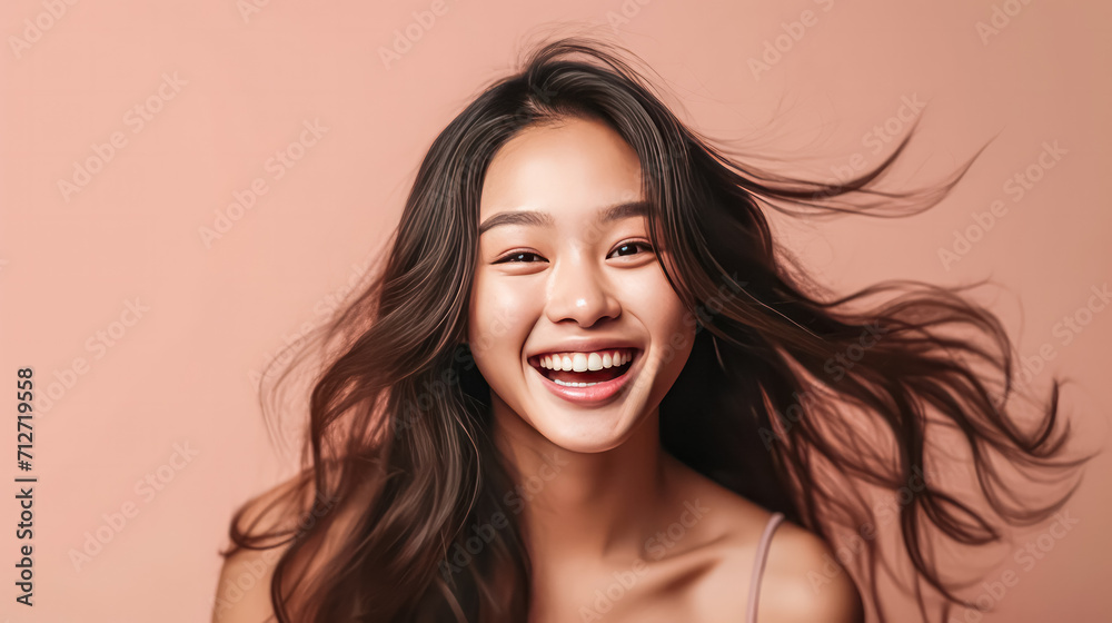 a girl of Asian appearance brightens a beige background a girl of Asian appearance brightens a beige background