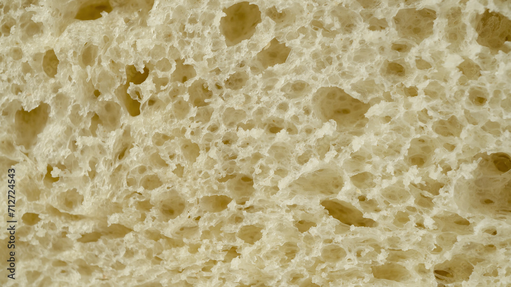 Macro shot of a slice of white wheat bread. Bakery texture background.