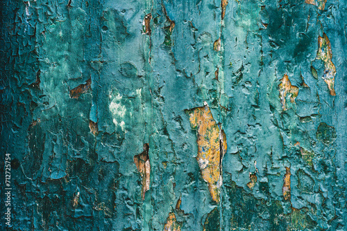 Old teal cracked paint on wooden door, textured background