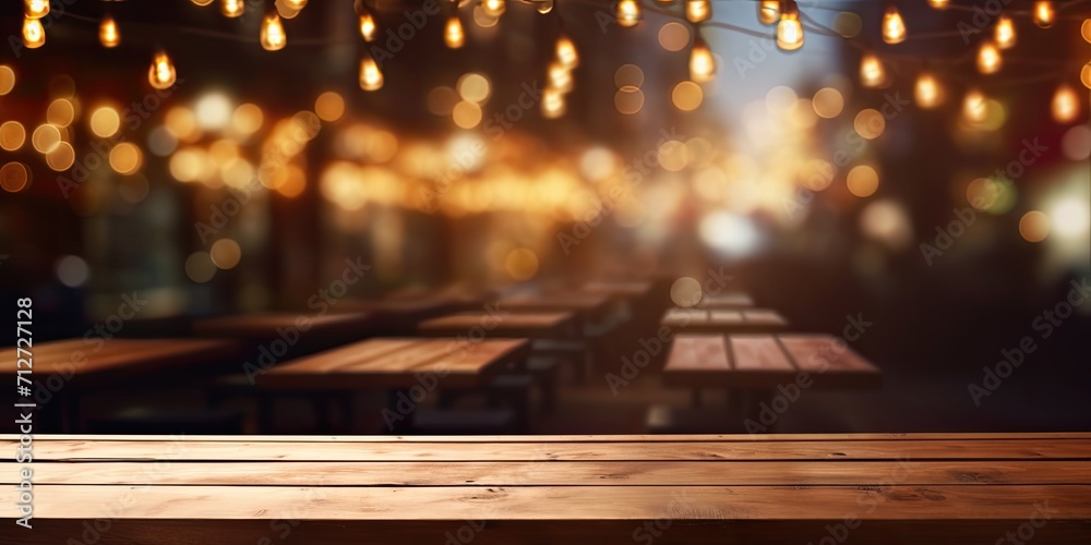 Blurred restaurant lights background with a wooden table in front.