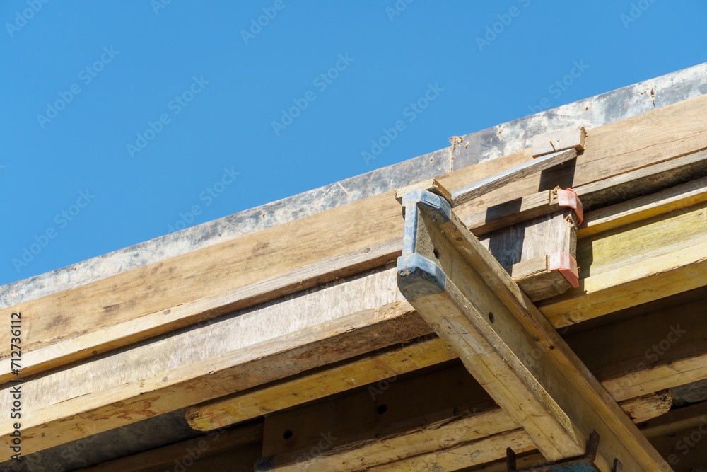 An outdoor construction site. Construction of a new building. Block construction, reinforced concrete beams and wooden floors and roofs. An outdoor construction site. Construction of a new building. Block construction, reinforced concrete beams and wooden floors and roofs.