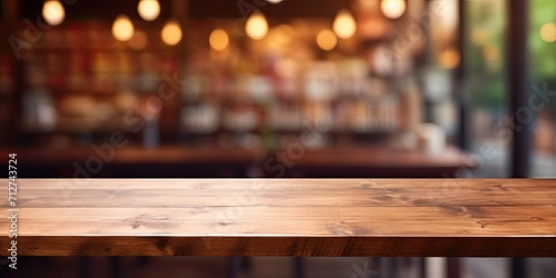 Blurred coffee shop backdrop with an empty wooden table.