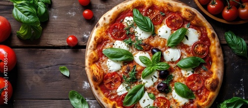 Tomato mozzarella olive basil pizza - top perspective.