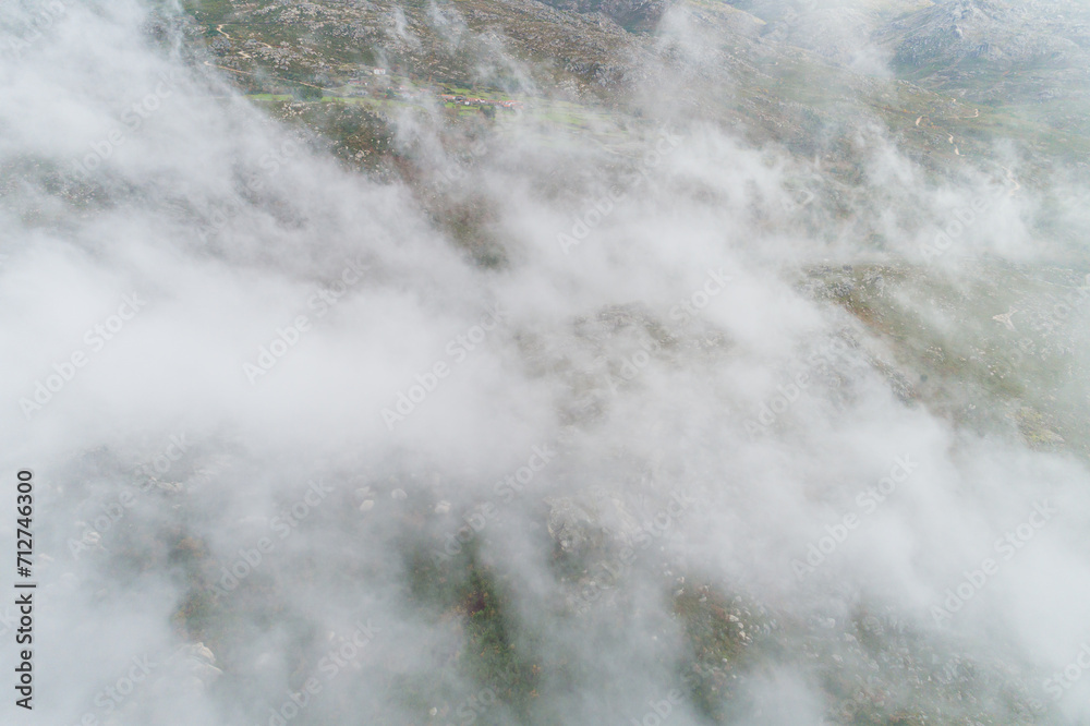 aerial drone view of a cloud covered mountain in southern Galicia, Spain