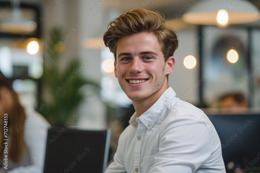 Obraz premium Young Man Working at Laptop Computer