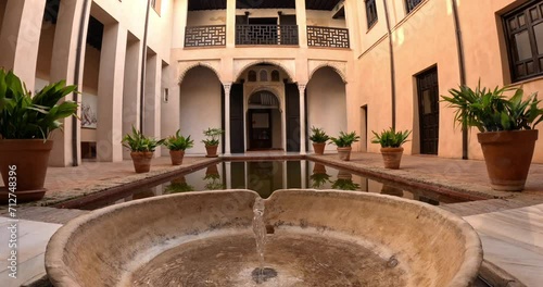 Beautiful arabian fountain in Granada, Spain, in a traditional coutryard or patio photo