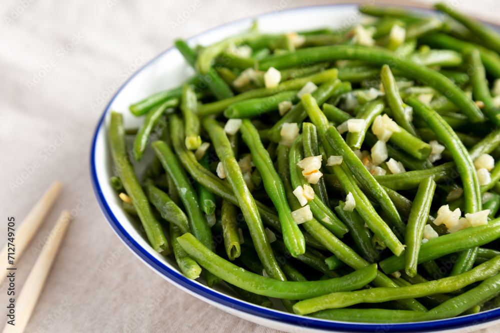 Homemade Asian Garlic Green Beans on a Plate, low angle view. Close-up. Homemade Asian Garlic Green Beans on a Plate, low angle view. Close-up.