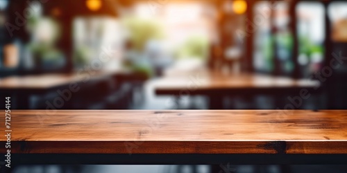 Blurry, brown wood table in a coffee shop can be used for product displays or design layouts. © Sona