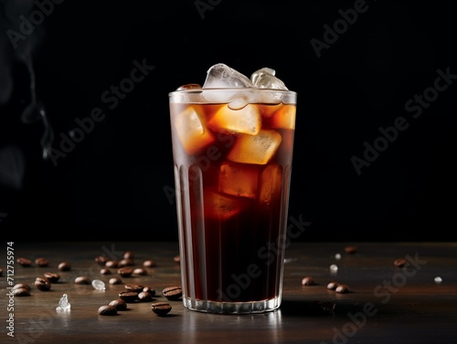 cola with ice cubes and coffee beans on a dark wooden background