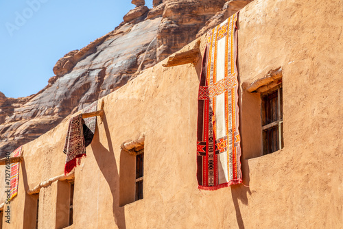 Ornated arabic carpets hanging from the roof of traditional mud houses, Al Ula, Medina province, Saudi Arabia photo