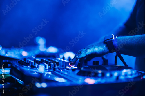 Close up of hands with mixing console making electro music on a festival.