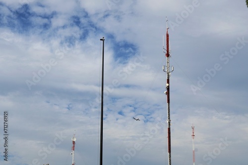 Wallpaper Mural An airplane on the horizon crosses in front of a row of telecommunications antennas. Torontodigital.ca