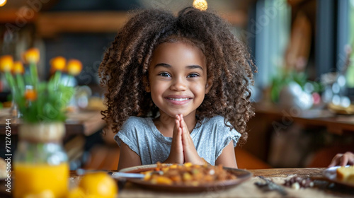 Little beautiful girl prays before eating