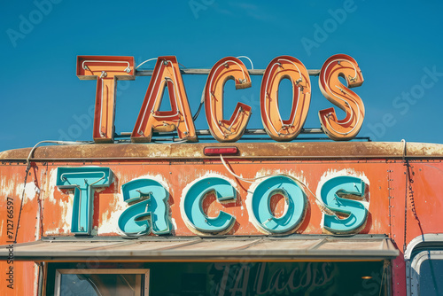 A mexican taco illuminated sign above a street food vendor truck. © ink drop