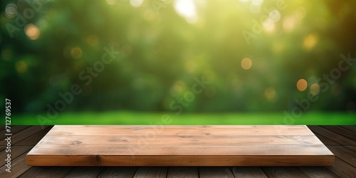 Montage or display products on blurred green lawn background with wooden table top.