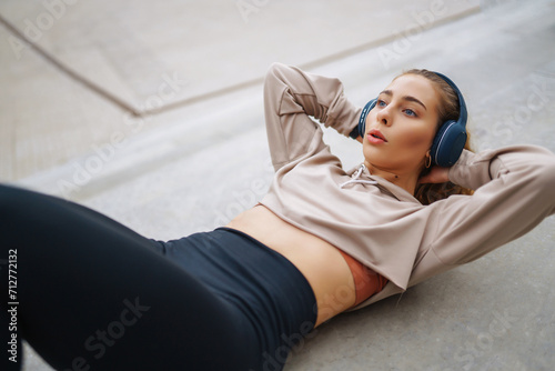 Happy woman in sports outfit doing exercises outdoors in the morning. Sport woman doing stretching exercise. Sport, Active life, sports training, healthy lifestyle.