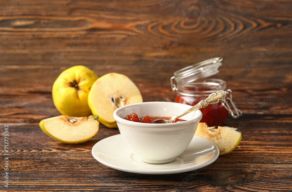 Bowl with jam and quince fruits on wooden background Bowl with jam and quince fruits on wooden background