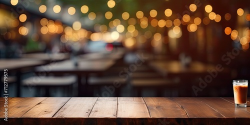 Blurred cafe/restaurant background with empty wooden table.