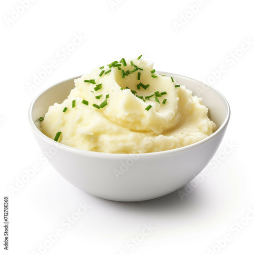 A bowl of mashed potatoes with butter, parsley and chives, isolated on white background