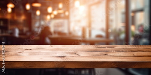 Wooden table with blurred coffee shop background, perfect for product displays or montages. © Sona