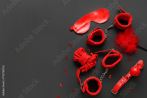 Fotografija Red BDSM accessories set with blindfold, cuffs, rope, gag, and feather tickler o