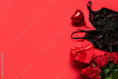 Sexy lingerie, rose flowers and gift for Valentine's Day celebration on red background