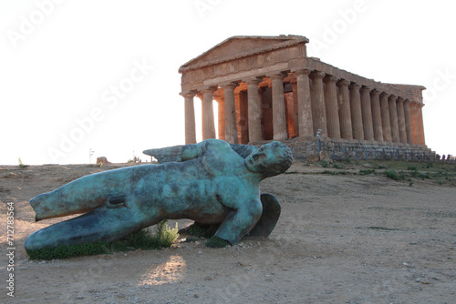 agrigento sicily italy ancient temple of concordia wide shot with damaged broken statue of man lying on its side in foreground
