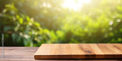 Wooden cutting board on table against natural background.