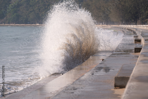 Huge waves are hitting seawall. photo