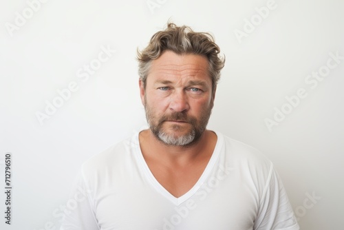 Portrait of a middle-aged man in a white T-shirt.