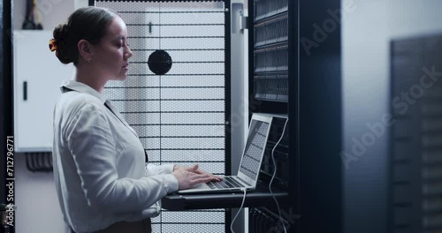 Business woman, data center and laptop for maintenance, system and hardware or software backup in cybersecurity. Asian technician with computer engineering, coding inspection and server room solution photo