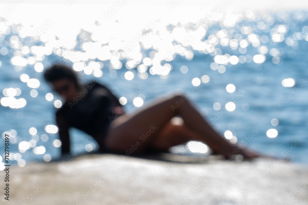 unidentifiable beautiful woman in bikini next to the sea in a sensual