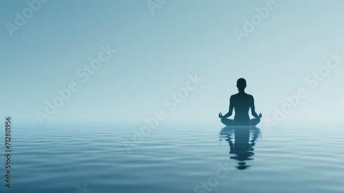 Silhouette of a person in a yoga pose by calm waters © Artyom