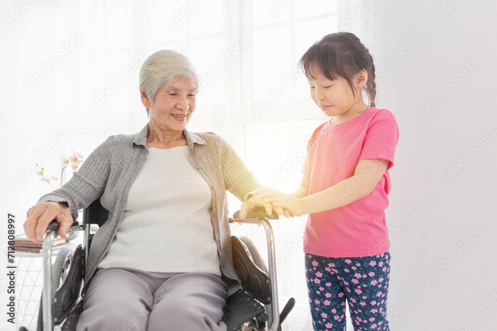 old asian patient sitting on wheelchair and taking with asian children, they feeling happy and smile in family time, rehabilitation activity old asian patient sitting on wheelchair and taking with asian children, they feeling happy and smile in family time, rehabilitation activity