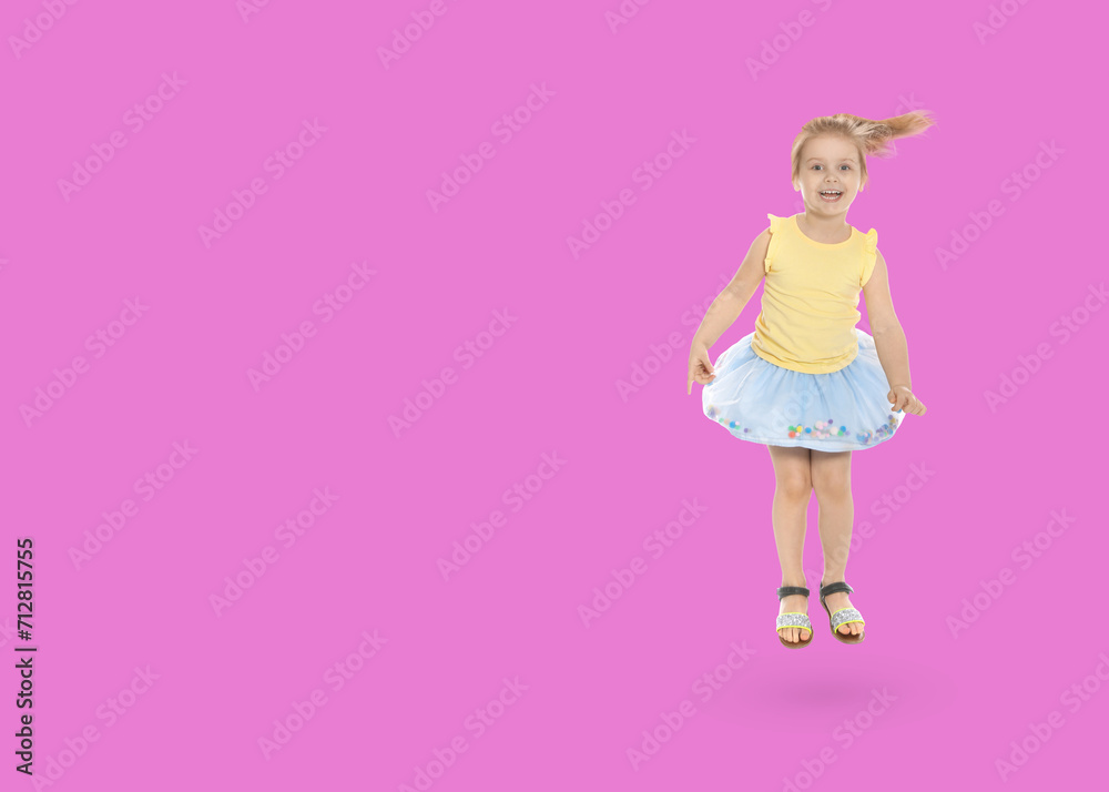 Cute girl jumping on pink background, space for text Cute girl jumping on pink background, space for text